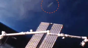 Cigar Shaped UFO Travelling With The Space Station